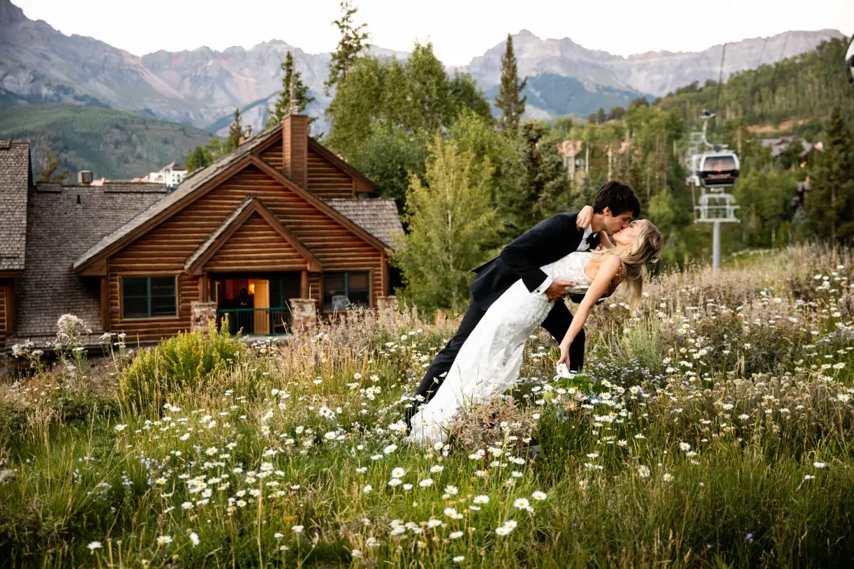 couple kissing in the meadow at mountain lodge telluride