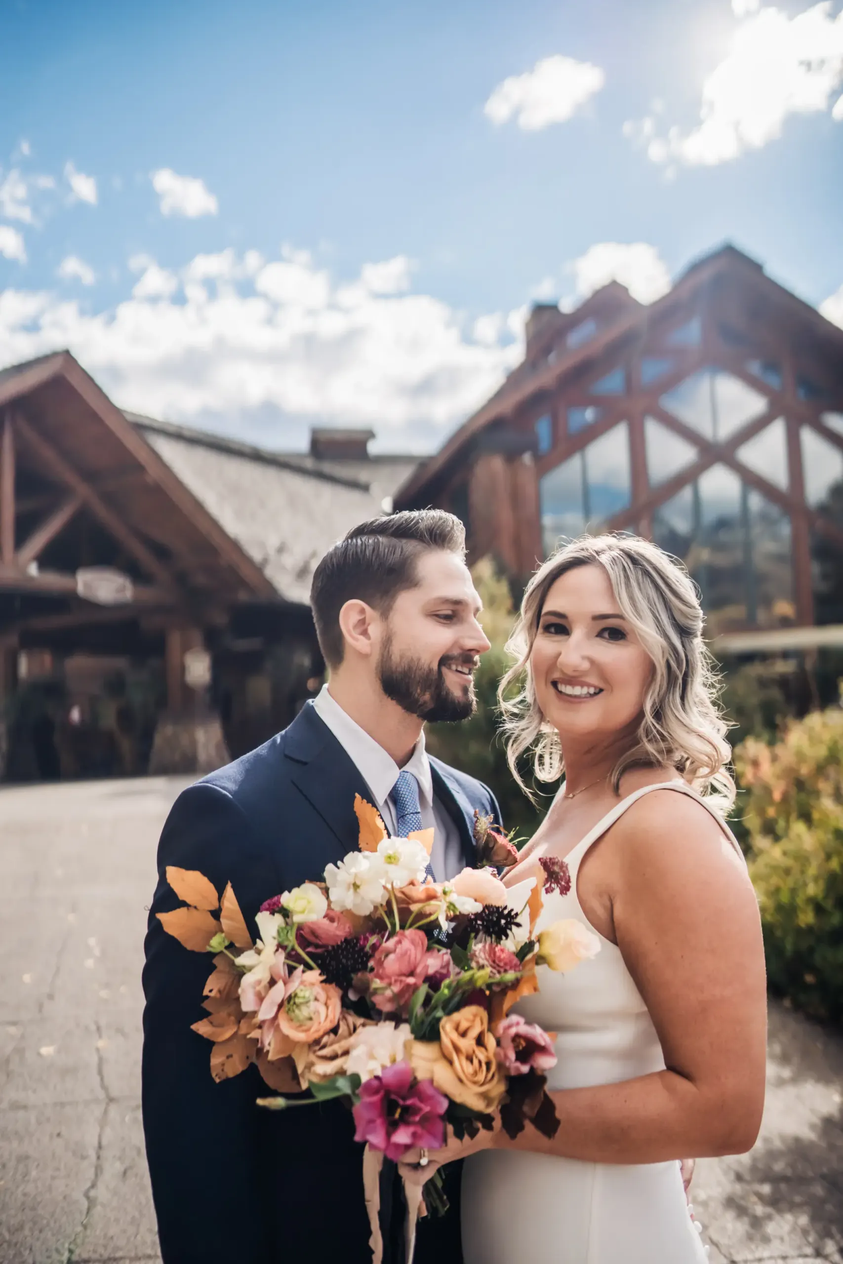 couple standing in front of mountain lodge telluride