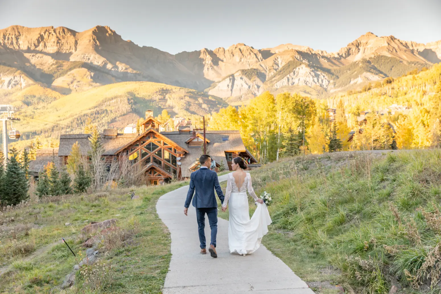 couple walking on the sidewalk at mountain lodge telluride